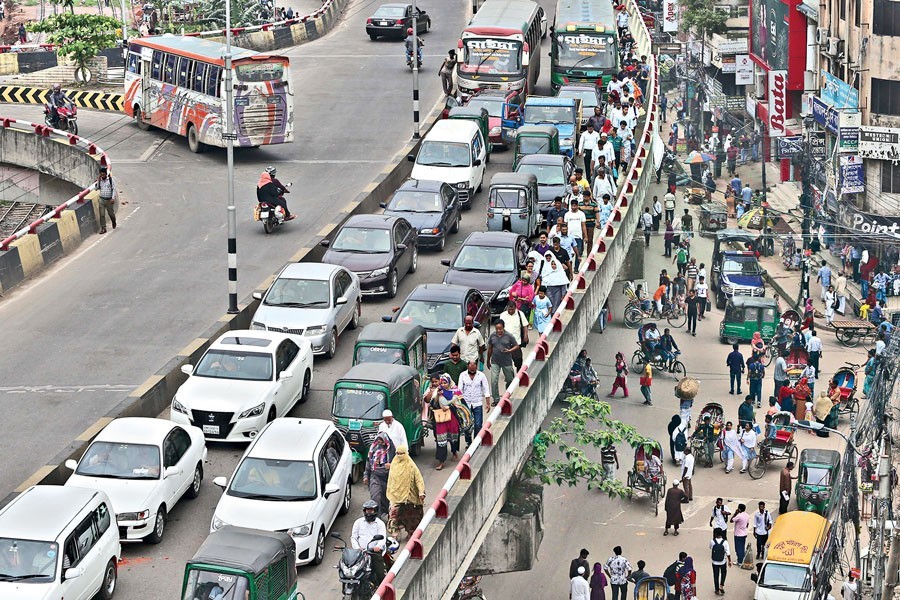 Representational image: In this July 08, 2019, file photo, commuters heading for their respective destinations on foot as vehicles, including private cars, were caught in a severe traffic jam on the Khilgaon flyover in Dhaka city while rickshaw pullers blockade some city points over the ban imposed on the tricycles on three roads — FE Photo
