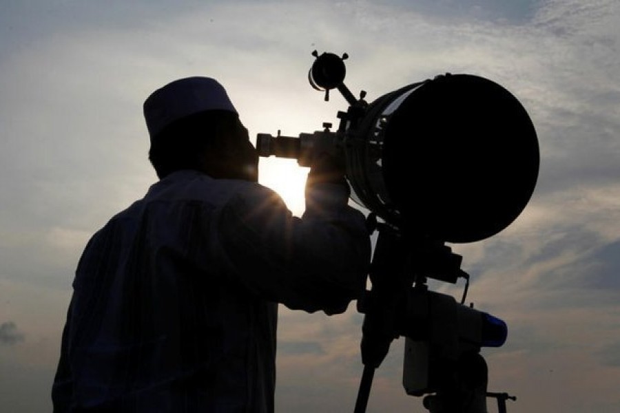 Representational image: A Muslim man uses a telescope to observe the moon before the Muslim holy month of Ramadan at Al-Musyari'in mosque in Jakarta, Indonesia, June 05, 2016. — Reuters/Files