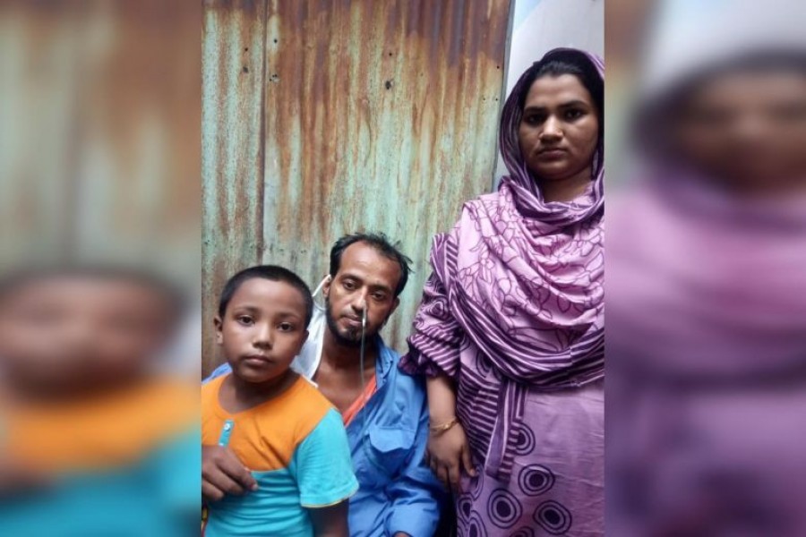 Sikdar Rana at home in Dhaka with his wife Moshumi Akhter, 27, and their six-year-old son Mahim — Courtesy of Dr Cynthia Goh via The Straits Times