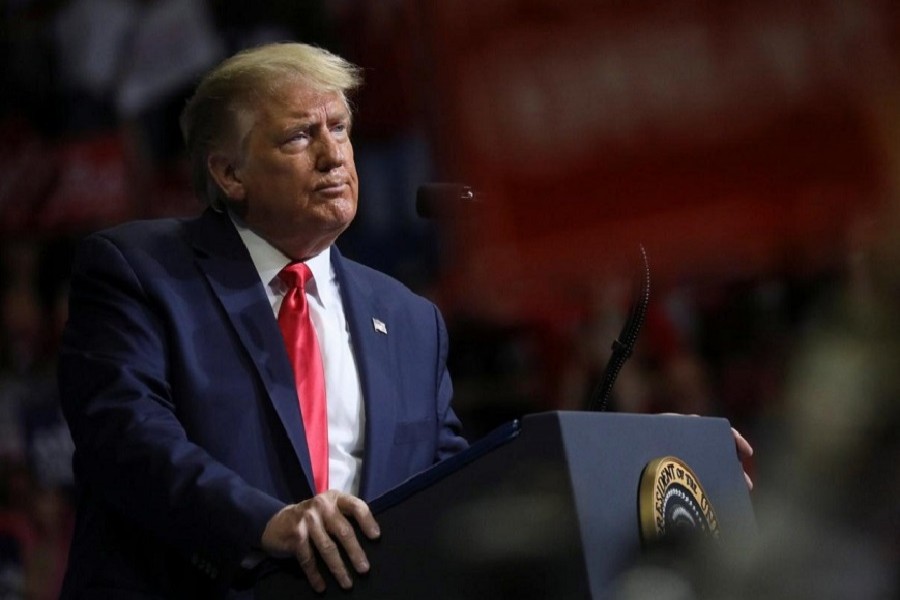 US President Donald Trump stands at the podium listening to his supporters cheer as he addresses his first re-election campaign rally in several months in the midst of the coronavirus disease (COVID-19) outbreak, at the BOK Center in Tulsa, Oklahoma, US, June 20, 2020 — Reuters