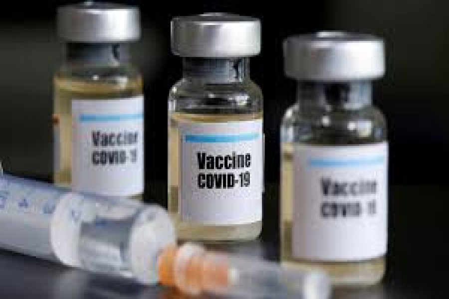 FILE PHOTO: Small bottles labeled with a "Vaccine COVID-19" sticker and a medical syringe are seen in this illustration taken taken April 10, 2020. REUTERS/Dado Ruvic/File Photo