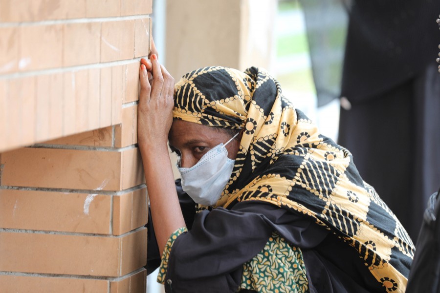 A woman with Covid-19 symptoms cuts a dejected figure outside Mugda General Hospital as she gets tired of waiting for coronavirus test — File photo