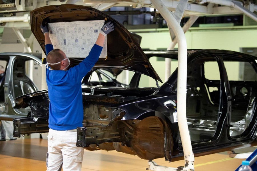 A worker wears a protective mask at the Volkswagen assembly line after VW re-starts Europe's largest car factory after coronavirus shutdown in Wolfsburg, Germany on April 27, 2020 — Swen Pfoertner/Pool via Reuters