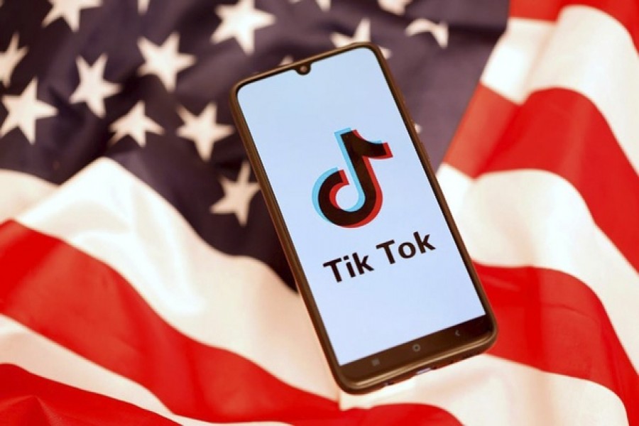 TikTok logo is displayed on the smartphone while standing on the US flag in this illustration picture taken, November 08, 2019 — Reuters/Files