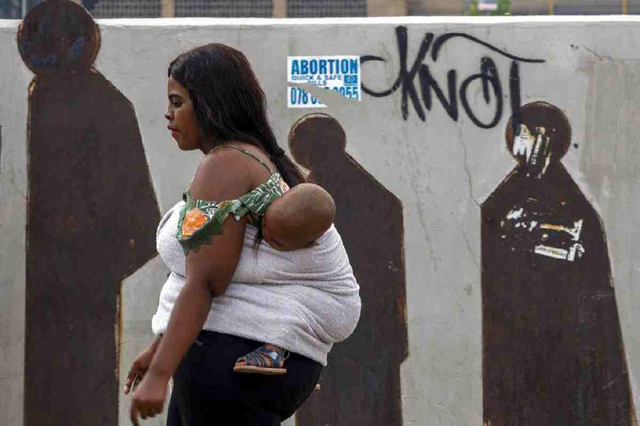 People walk along a downtown street in Johannesburg, South Africa. Millions of women and girls globally have lost access to contraceptives, abortion services and related care because of the coronavirus pandemic. AP Photo
