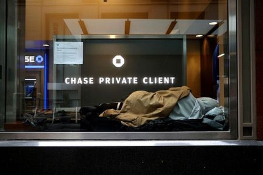 A homeless man sleeps in a closed Chase bank branch on a nearly deserted Wall Street in the financial district in lower Manhattan during the outbreak of the coronavirus disease (Covid-19) in New York City, New York, US, April 3, 2020 — Reuters/Files