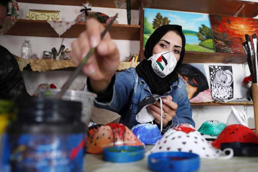 A Palestinian artist paints protective face masks to encourage people to wear them as a precaution against the coronavirus disease (COVID-19), in Gaza City —Reuters Photo