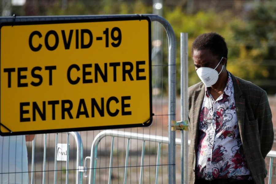 A man stands near a sign for a Covid-19 test centre amid the coronavirus disease (Covid-19) outbreak, in Bolton, Britain on September 17, 2020 — Reuters photo