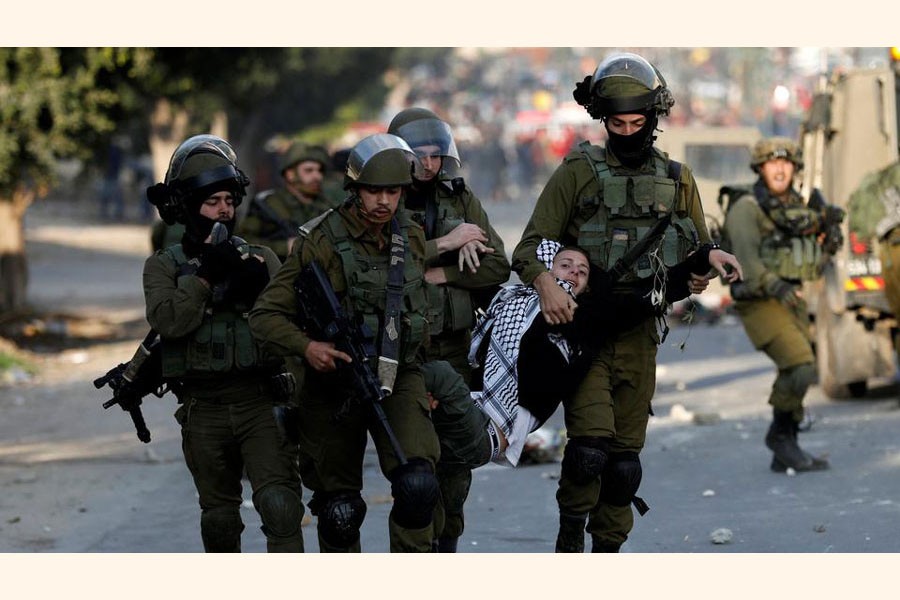 Israeli soldiers detain a Palestinian youth during a protest against US President Donald Trump's decision to recognise Jerusalem as the capital of Israel, near the West Bank city of Nablus December 15, 2017 —Reuters