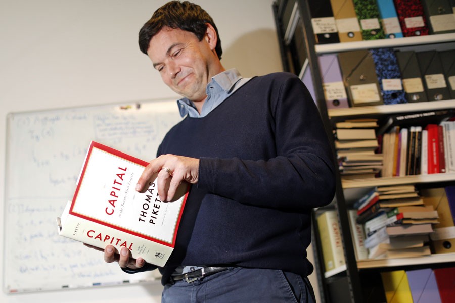 French economist and academic Thomas Piketty with his magnum opus Capital in the Twenty First Century - Reuters