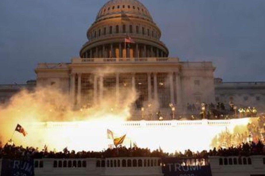 An explosion caused by a police munition is seen while supporters of U.S. President Donald Trump gather in front of the U.S. Capitol Building in Washington, US, January 6, 2021. REUTERS/Leah Millis