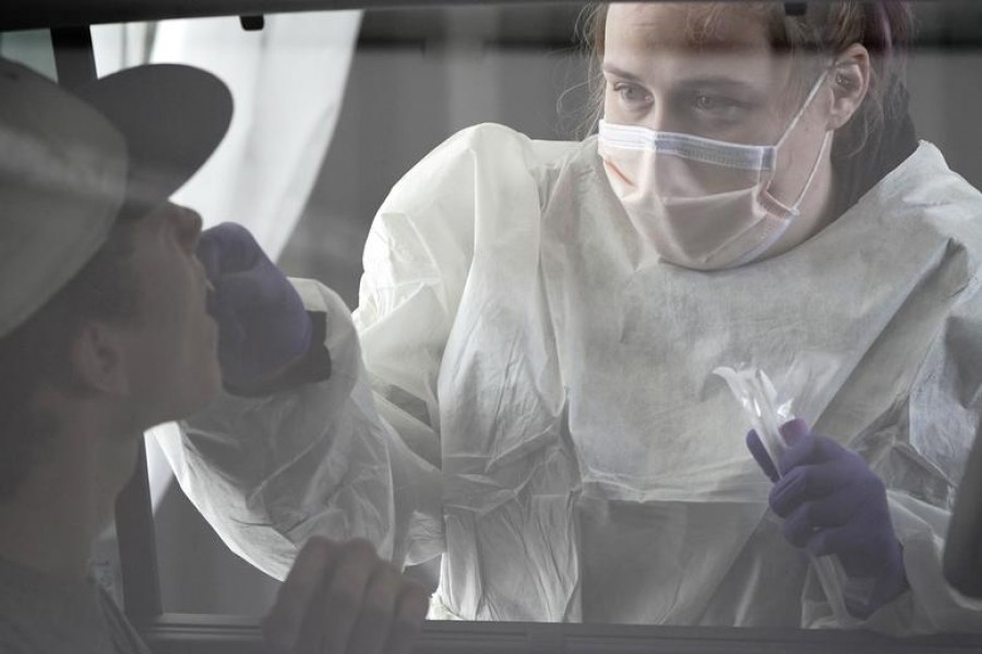 Registered nurse (RN) Amanda Pierce takes a young patient's nasal swab at a coronavirus disease (Covid-19) drive-thru testing site at Froedtert North Hills Health Center in Menomonee Falls, Wisconsin, US — Reuters/Files