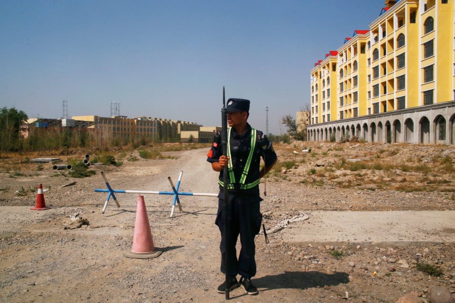 A Chinese police officer takes his position by the road near what is officially called a vocational education center in Yining in Xinjiang Uighur Autonomous Region, China, September 4, 2018. REUTERS