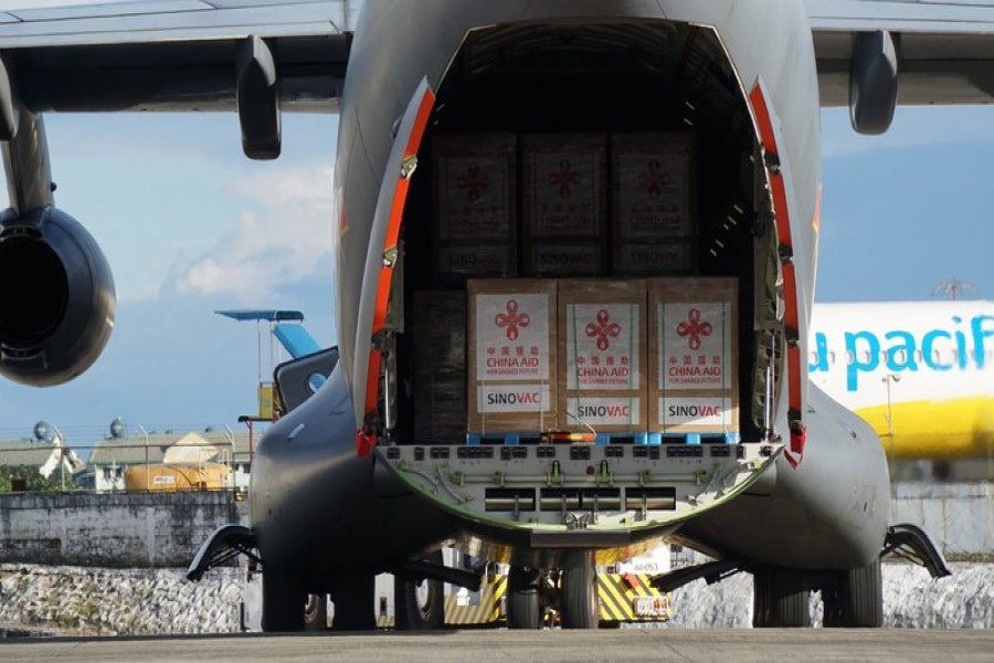 In this photo provided by the Presidential Communications Operations Office-Office of the Global Media Public Affairs, a Chinese military plane carrying the first batch of Sinovac vaccine from China arrives at the Villamor Air Base in Manila, Philippines on Sunday Feb. 28, 2021. (PCOO-OGMPA via AP)