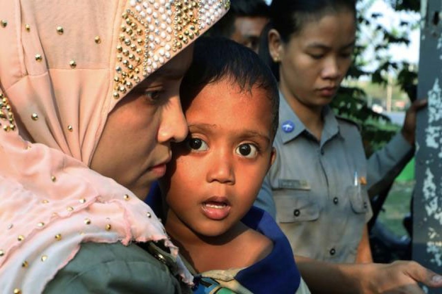 FILE PHOTO: Arrested Rohingya people leave a Hlegu court, outside Yangon, Myanmar, February 21, 2020. REUTER