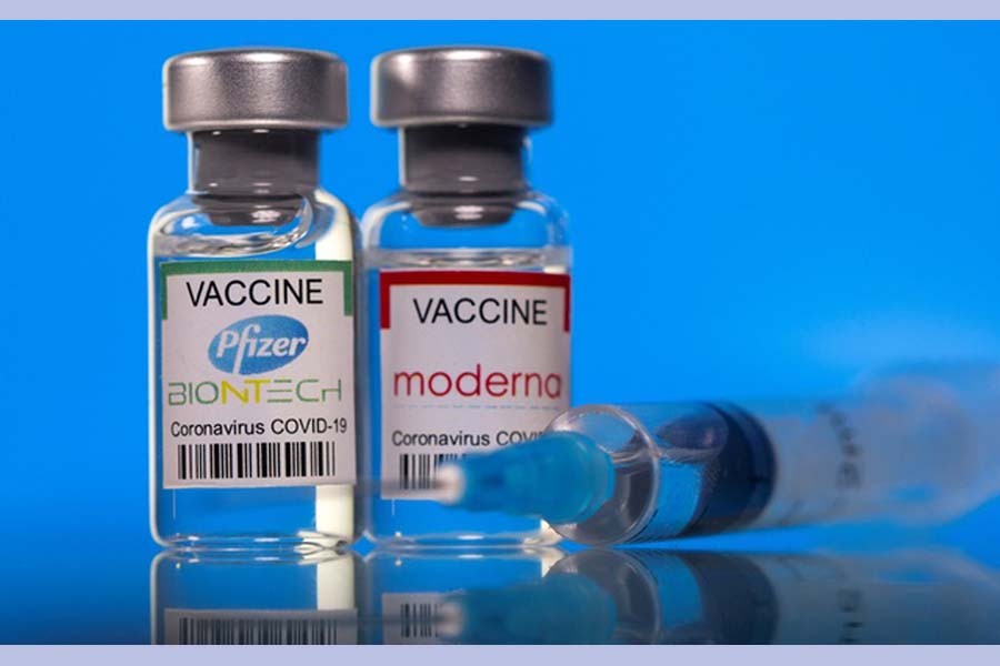 Vials with Pfizer-BioNTech and Moderna coronavirus disease (COVID-19) vaccine labels are seen in this illustration picture taken Mar 19, 2021. REUTERS