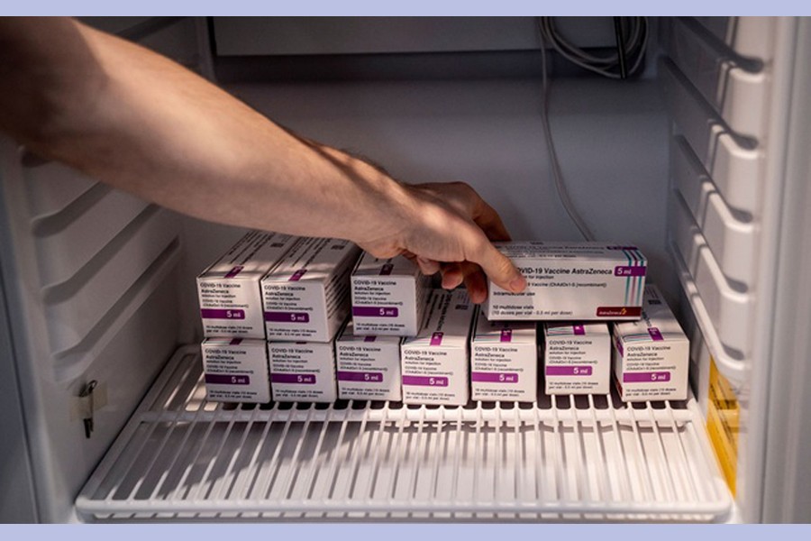 Staff member handles AstraZeneca COVID-19 vaccines in storage at Region Hovedstaden's Vaccine Centre, Copenhagen, Denmark February 11, 2021. REUTERS