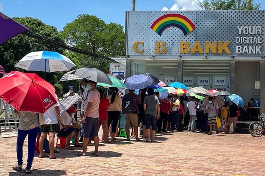 People line up outside a bank to withdraw cash, in Yangon on Thursday –Reuters photo