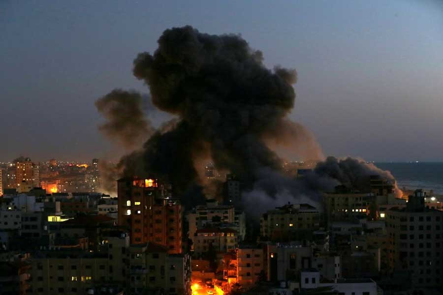 Smoke rising from a building after it was destroyed by Israeli air strikes amid a flare-up of Israeli-Palestinian violence in Gaza on May 11 –Reuters file photo