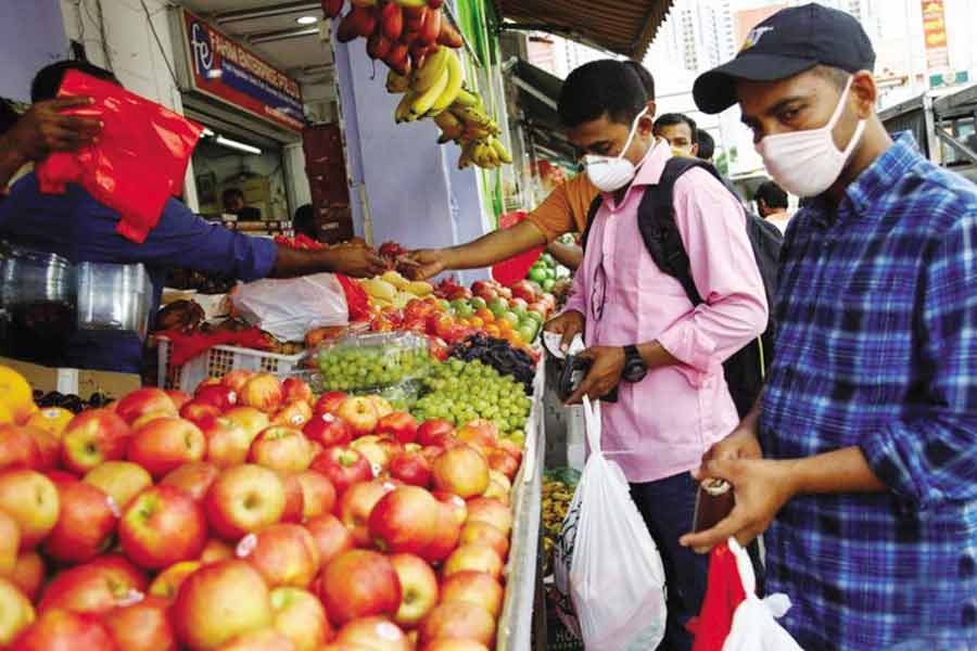 Migrant workers mostly from Bangladesh shop for groceries on their day off in Singapore. -Reuters photo