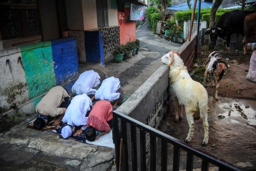 Indonesian Muslims offer Eid al-Adha prayers on the street amid a surge of coronavirus disease (Covid-19) cases in Bandung, West Java province, Indonesia Jul 20, 2021. REUTERS