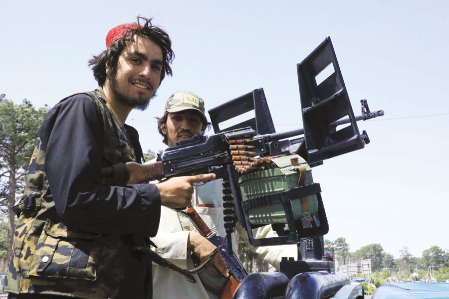 Taliban fighters patrol a street in the city of Herat. —Reuters photo