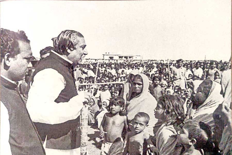 Bangabandhu Sheikh Mujibur Rahman among the cyclone affected people, listening to the stories of their sufferings in 1974. Photo: mujib100.gov.bd