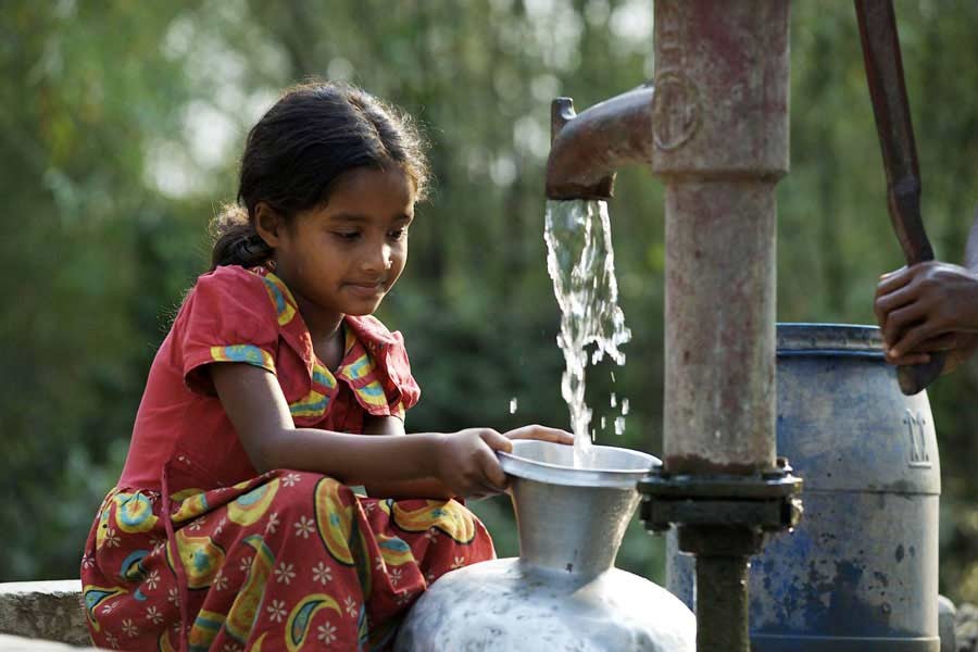 A girl collecting drinking water from a tube well at a village in Bangladesh. —UNICEF Photo
