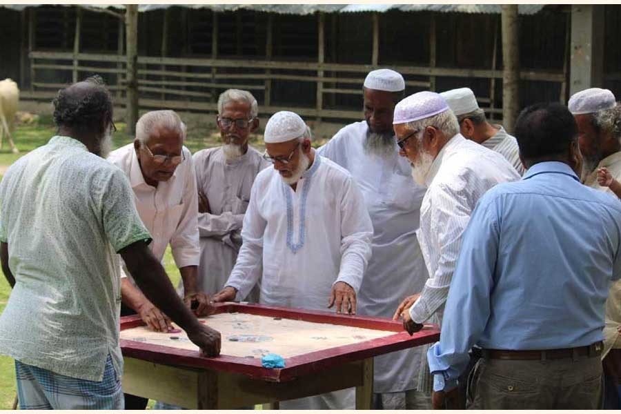 Some elderly persons enjoying carom board game at a social centre in Bangladesh. —RIC Photo