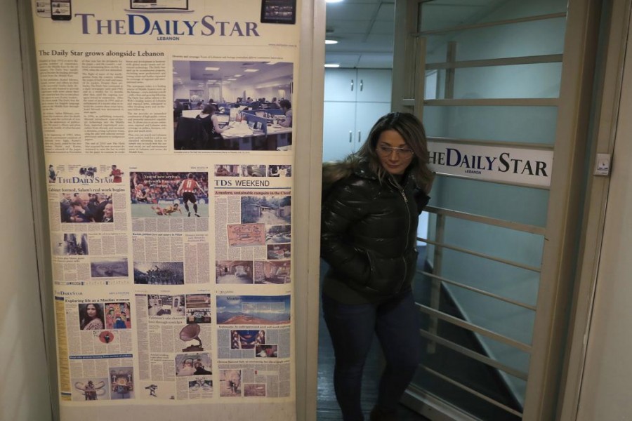 An employee of The Daily Star newspaper opens the main door of the newspaper office, in Beirut, Lebanon, Tuesday, Feb. 4, 2020. Photo: AP