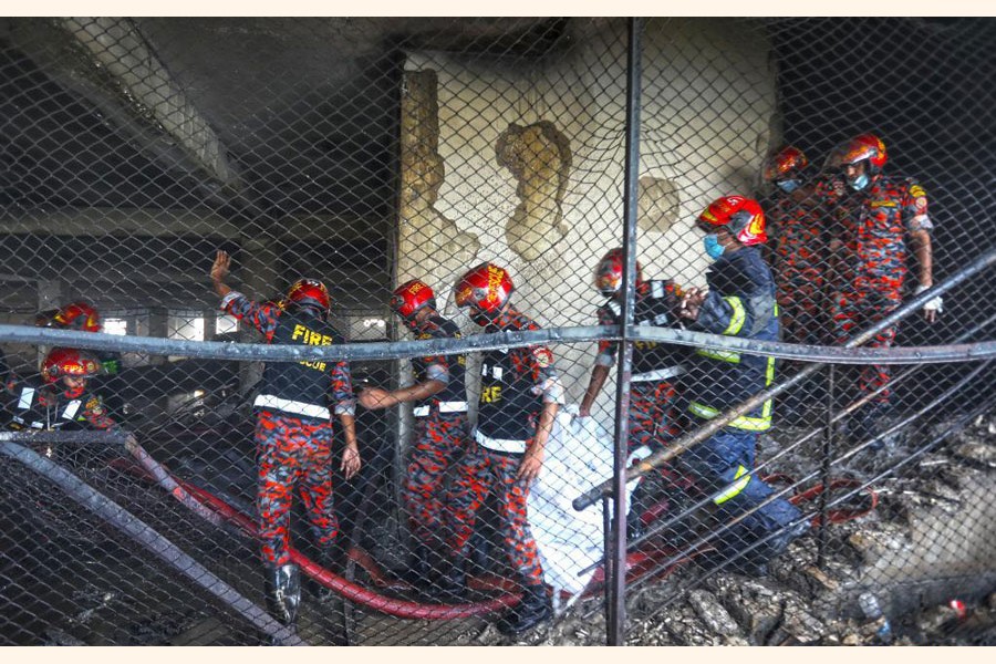 Firefighters work at the fire site of a juice factory in Narayanganj on the outskirts of Dhaka, Bangladesh, on July 9, 2021. At least 52 people have died as a huge fire raged for a second day in the juice factory in Narayanganj. —Xinhua Photo