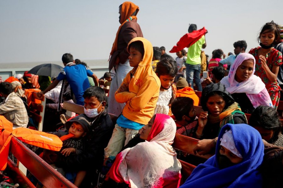 Rohingya refugees sit on wooden benches of a navy vessel on their way to the Bhasan Char island in Noakhali district Rohingya refugees sit on wooden benches of a navy vessel on their way to the Bhasan Char island in Noakhali district, Bangladesh on December 29, 2020 — Reuters/Files