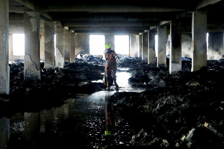A firefighter leaves the Hashem Foods Ltd factory building where a fire broke out on July 08, 2021 as it is fully extinguished, in Rupganj, Narayanganj district —Reuters Photo