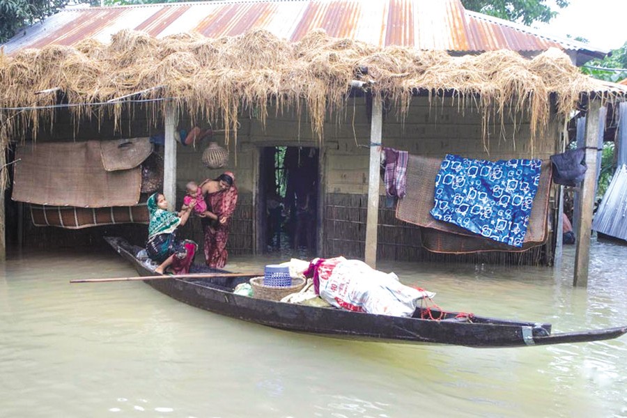 People prepare to move by boat from a flood-affected area to a safe place in Sylhet, Bangladesh, on June 19, 2022. —Xinhua Photo