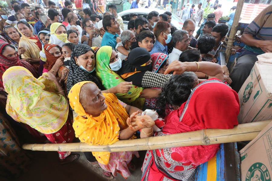 People are trying to purchase subsidised food items from a truck run by Trading Corporation of Bangladesh in Dhaka —FE File Photo