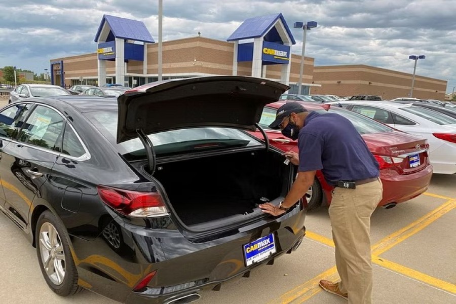 Brandon Parrum, general manager of CarMax's Des Moines store, shows off one of the many vehicles that customers can arrange to buy online and collect at the store using "contactless" curbside pickup, a service the US used car retailer launched during the coronavirus disease (COVID-19) pandemic, in De Moines, Iowa, US July 29, 2020. REUTERS