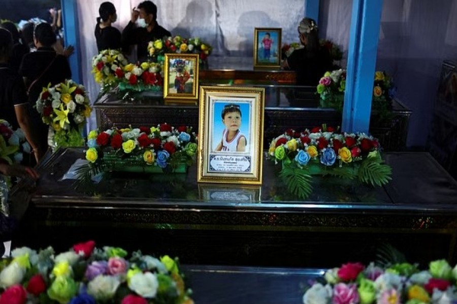 Locals decorate the coffins of victims with flowers at Sri Uthai temple in Na Klang district, following a mass shooting in the town of Uthai Sawan in the province of Nong Bua Lam Phu, Thailand Oct 7, 2022. REUTERS/Athit Perawongmetha