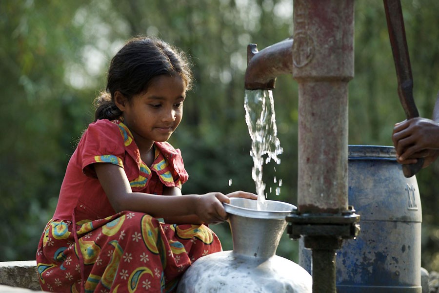 A child is collecting drinking water from a tubewell. Safe and clean water is still a big challenge in Bangladesh. —UNICEF Photo